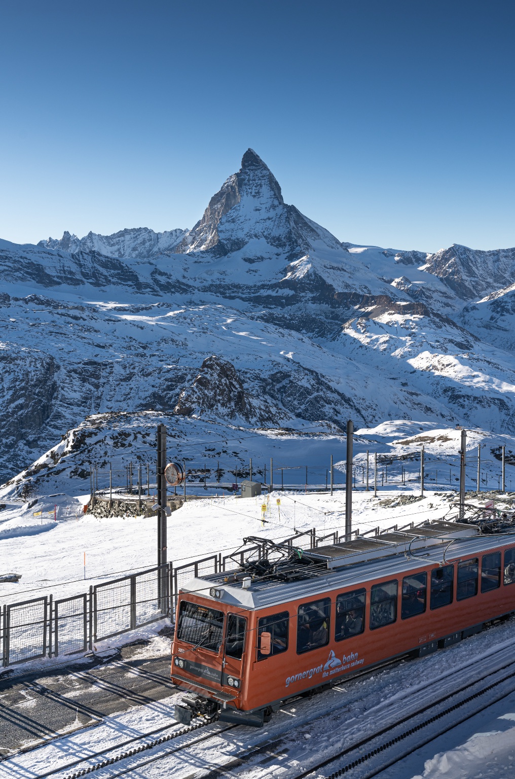 The Matterhorn rising above a snowy mountain railway